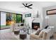 Bright living room featuring a modern fireplace, ceiling fan, and sliding glass doors to the outdoor space at 357 S Franklin St, Denver, CO 80209