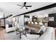 Open-concept living room with kitchen view, modern furnishings, hardwood floors, and an open staircase at 357 S Franklin St, Denver, CO 80209
