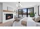 A contemporary main bedroom featuring a fireplace and large window with neighborhood view at 357 S Franklin St, Denver, CO 80209