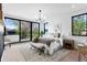 Bright bedroom with large windows and modern chandelier with an upholstered bench in view at 357 S Franklin St, Denver, CO 80209