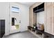 Mudroom boasting custom built-ins for storage, seating and a tiled floor at 357 S Franklin St, Denver, CO 80209