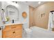 Bathroom boasts modern fixtures, wood tile shower, and vanity with marble floors at 6498 S Everett Way, Littleton, CO 80123