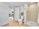 Modern bathroom featuring a decorative shower stall and an adjacent living space at 6498 S Everett Way, Littleton, CO 80123
