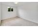 Bare bedroom with large window providing lots of natural light and neutral carpeting at 6498 S Everett Way, Littleton, CO 80123