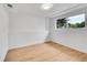 Clean, minimalist bedroom with natural light and light wood flooring at 6498 S Everett Way, Littleton, CO 80123