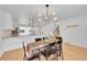 Bright dining room with modern chandelier and a view of the staircase and kitchen at 6498 S Everett Way, Littleton, CO 80123