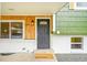 Close up of the home's front door and welcome mat, accented by wood paneling at 6498 S Everett Way, Littleton, CO 80123