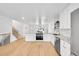 Bright and open kitchen with white cabinets, island, and stainless-steel appliances at 6498 S Everett Way, Littleton, CO 80123