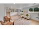 Bright lower level living room with modern decor and stairs to upper level at 6498 S Everett Way, Littleton, CO 80123