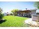 Large backyard with a covered patio, lush grass, a hot tub, and space for outdoor entertaining at 4360 S Braun Ct, Morrison, CO 80465