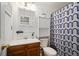 Cozy bathroom featuring a classic vanity with a wooden base and a blue patterned shower curtain at 4360 S Braun Ct, Morrison, CO 80465