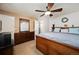 Spacious bedroom with a bed, dresser, and a large mirror and a ceiling fan at 4360 S Braun Ct, Morrison, CO 80465