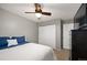Comfortable bedroom with a ceiling fan, closet with sliding doors and blue accents at 4360 S Braun Ct, Morrison, CO 80465