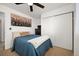Inviting bedroom with a bed, closet with sliding doors and a large artwork on the wall at 4360 S Braun Ct, Morrison, CO 80465