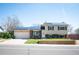 Charming home with solar panels, a manicured front lawn, and an attached two-car garage at 4360 S Braun Ct, Morrison, CO 80465
