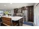 Bright kitchen featuring modern appliances, center island with seating, and seamless flow to the living space at 4360 S Braun Ct, Morrison, CO 80465