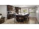Inviting kitchen boasts an island with seating, stainless steel appliances, and dark wood cabinetry for storage at 4360 S Braun Ct, Morrison, CO 80465