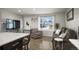 Bright, open concept view from kitchen to the living area featuring a large window at 4360 S Braun Ct, Morrison, CO 80465