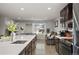 Bright, open concept view from kitchen to the living area featuring a large window with mountain views at 4360 S Braun Ct, Morrison, CO 80465