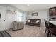 Comfortable living room showcasing neutral walls, wood floors, and natural light from large window at 4360 S Braun Ct, Morrison, CO 80465