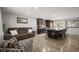 Open concept living area with kitchen, wood floors, stylish furnishings, and bright natural light at 4360 S Braun Ct, Morrison, CO 80465