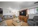 Inviting living room features a comfortable sofa, a large entertainment center, and bright natural light at 4360 S Braun Ct, Morrison, CO 80465