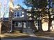 Inviting townhome exterior with stone accents, neutral siding, and mature landscaping at 18356 E Arizona Ave # E, Aurora, CO 80017