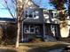 Charming townhome featuring a stone facade, neutral siding, and a well-manicured lawn at 18356 E Arizona Ave # E, Aurora, CO 80017