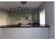 Kitchen features an open counter, ample counterspace, and light green cabinets at 18356 E Arizona Ave # E, Aurora, CO 80017