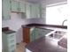 Charming kitchen with light green cabinets, granite countertops, and modern sink at 18356 E Arizona Ave # E, Aurora, CO 80017
