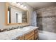 Updated bathroom with a tub, shower, and wood vanity at 8690 Allison St # H, Arvada, CO 80005