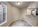 Simple dining area with tile floor and kitchen access at 8690 Allison St # H, Arvada, CO 80005