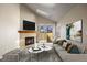 Bright living room featuring a fireplace, skylight, and sliding glass doors to a private outdoor space at 8690 Allison St # H, Arvada, CO 80005