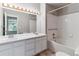 Bathroom with double sinks, tile floors and a shower/tub combo at 2575 S Syracuse Way # 101, Denver, CO 80231