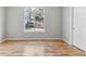 A bedroom boasts hardwood floors, a large window, and neutral walls for a serene and inviting atmosphere at 2575 S Syracuse Way # 101, Denver, CO 80231