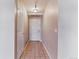 Hallway view featuring tile flooring, a white front door, and a closet door on the left at 2575 S Syracuse Way # 101, Denver, CO 80231
