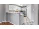 Open kitchen features white cabinets, stainless steel appliances, and a breakfast bar at 2575 S Syracuse Way # 101, Denver, CO 80231
