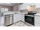Bright kitchen boasts white cabinets, stainless steel appliances, and functional layout at 2575 S Syracuse Way # 101, Denver, CO 80231