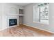Inviting living room featuring a cozy fireplace with tile surround and a large arched window at 2575 S Syracuse Way # 101, Denver, CO 80231