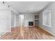 Spacious living room with hardwood floors, fireplace, mantel and large arched window at 2575 S Syracuse Way # 101, Denver, CO 80231
