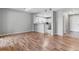 Living room view featuring hardwood floors, view into kitchen and the entry hallway at 2575 S Syracuse Way # 101, Denver, CO 80231