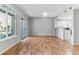 Bright living room with hardwood floors, sliding glass doors to balcony, and a kitchen bar at 2575 S Syracuse Way # 101, Denver, CO 80231