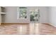 Open concept living room filled with natural light featuring hardwood floors and a sliding glass door to the patio at 2575 S Syracuse Way # 101, Denver, CO 80231