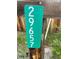 Close-up of the property address sign with green background and clear white numbers at 29657 Loomis Way, Golden, CO 80403