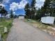 Long gravel driveway leading to a home featuring an attached two-car garage and ample parking at 29657 Loomis Way, Golden, CO 80403