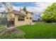 Spacious backyard featuring a well-maintained lawn, wood fence, and lush trees, ideal for outdoor activities at 12319 W Burgundy Ave, Littleton, CO 80127