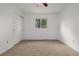 Bright bedroom featuring neutral carpet, closet, window, and ceiling fan at 12319 W Burgundy Ave, Littleton, CO 80127