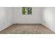 Empty room with neutral carpet, bright with natural light from the window at 12319 W Burgundy Ave, Littleton, CO 80127