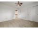Neutral carpeted bedroom featuring a closet and entry to the stairway at 12319 W Burgundy Ave, Littleton, CO 80127