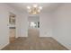 Dining room featuring neutral carpet, a decorative light fixture, and open layout to the kitchen and living room at 12319 W Burgundy Ave, Littleton, CO 80127